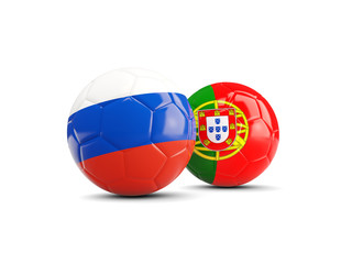 Two footballs with flags of Russia and Portugal isolated on white