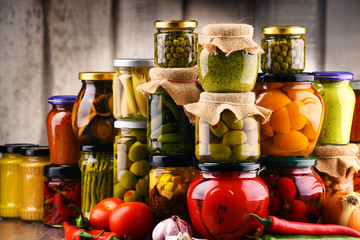 Jars with variety of pickled vegetables.