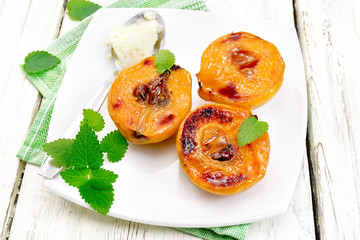 Quince baked with ice-cream and mint in plate on board
