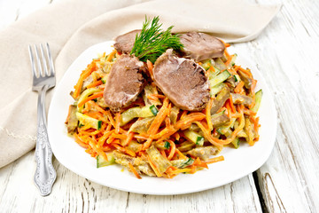 Salad of tongue and carrots on light board