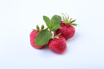 Fresh strawberries and mint leaves isolated on white background. Selective focus.