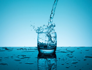 Creative splashing water in the glass