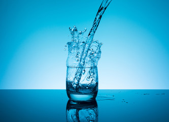 Creative splashing water in the glass