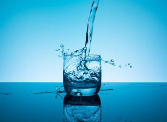 Creative splashing water in the glass