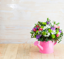 Fototapeta na wymiar bouquet of flowers in watering can