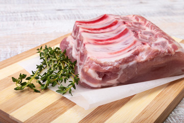 Raw pork chops, spices and rosemary on cutting board. Ready for cooking.