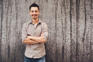 Handsome man outdoors portrait in the city. Warm colors