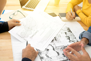 Architects (or landscape designers) discussing blueprints