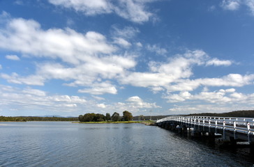 Fototapeta na wymiar Bridge across Wallaga Lake. The famous and spiritual area of Wallaga Lake, the largest lake in southern NSW, near Bermagui in New South Wales, Australia.