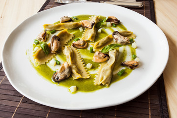 Egg pasta stuffed with mussels and vegetables in the restaurant.