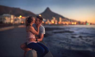 Young couple kiss at sunset romantic moment - obrazy, fototapety, plakaty
