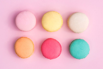 Fototapeta na wymiar Colorful pastel cake macaron or macaroon on pink background from above