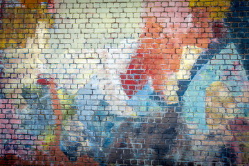 Multi coloured graffiti painted brick wall background