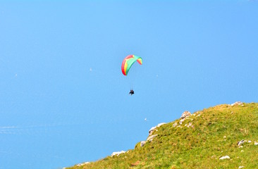 Paragliding on the blue sky on Lake Garda in Italy.