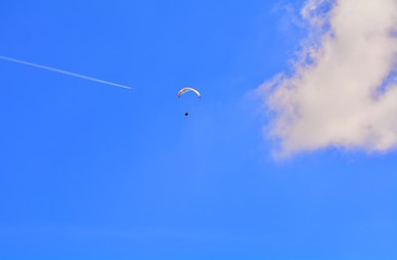 Paragliding on the blue sky on Lake Garda in Italy.