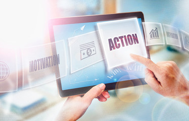 A businesswoman selecting a Action business concept on a futuristic portable computer screen.