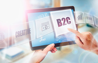 A businesswoman selecting a B2C business concept on a futuristic portable computer screen.