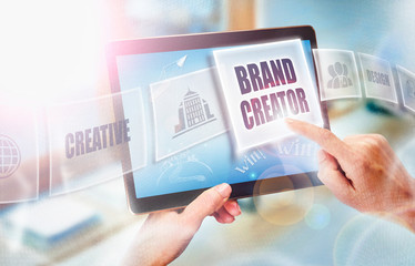 A businesswoman selecting a Brand Creator business concept on a futuristic portable computer screen.