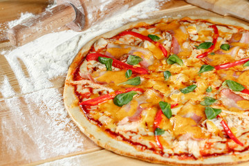 Baked pizza with chicken and paprika and ingredients. Italian traditional food. Selective focus