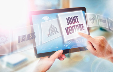 A businesswoman selecting a Joint Venture business concept on a futuristic portable computer screen.