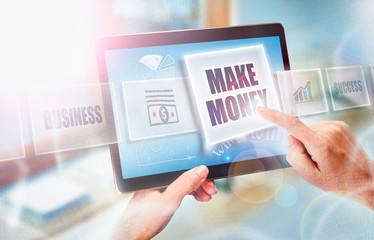 A businesswoman selecting a Make Money business concept on a futuristic portable computer screen.