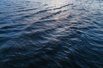 Flight at sunset over the waves of the Baltic Sea 