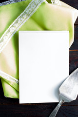 Clean notepad for entries with a napkin and a metal spatula for a cake, top view