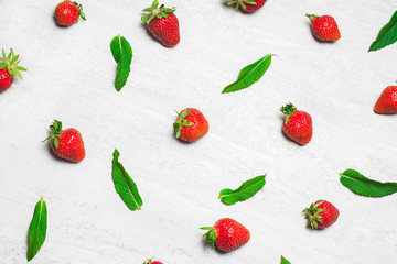 White concrete rustic background with strawberries. Summer healthy eating concept. Flat lay, top view