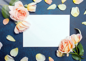 Beautiful cream pastel roses on concrete background. Wedding concept. Top view, flat lay. Copy space.