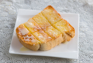 Toast with sweetened condensed milk in white plate