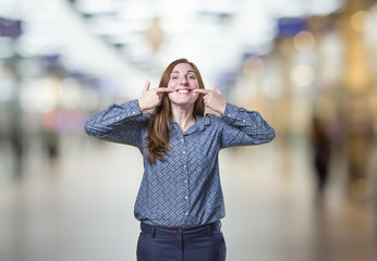Pretty business woman making a smile gesture over blur background