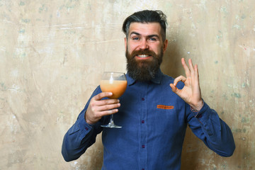 Brutal hipster holding tropical alcoholic fresh cocktail