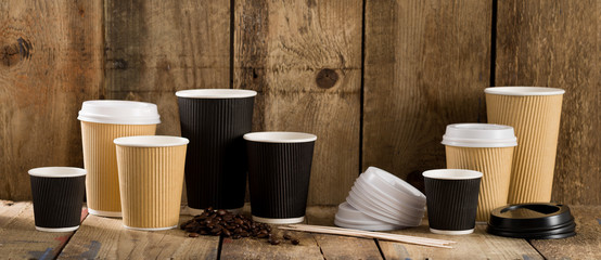 Paper Cups of Varying Sizes, Coffee Beans, and Wooden Stirrers