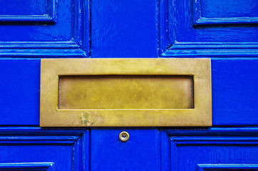 Old letterbox in the door, traditional way of delivering letters to the house, old mailbox