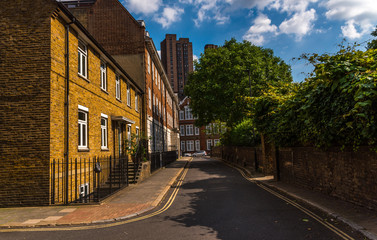 Typical old English buildings, low brick buildings across a narrow street, interesting old London architecture