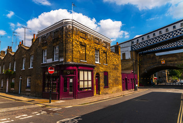 Typical old English buildings, low brick buildings across a narrow street, interesting old London...