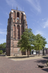 old lopsided tower oldehove and dog in the center of ancient city Leeuwarden in the netherlands