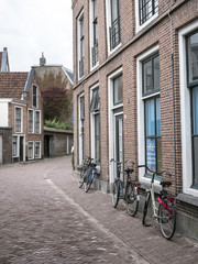 Fototapeta na wymiar bicycles are parked against house in the centre of old capital Leeuwarden of province of friesland in the netherlands