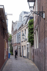 man on bicycle and old houses in the centre of old capital Leeuwarden of province of friesland in the netherlands