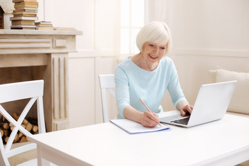 Lively bright lady writing down some tips