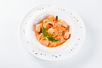 Risotto with shrimp and salmon in a mild creamy sauce (close)