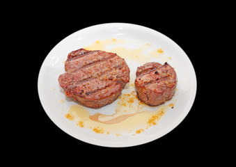 Sirloin steak over plate on black background