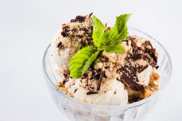 Ice cream in glass bowl on white background (close up)
