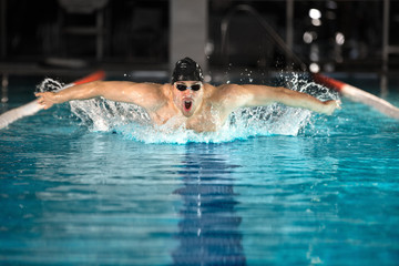 Young male swimmer swimming the butterfly stroke