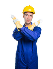 Serious workman doing a gesture of prohibition on white background