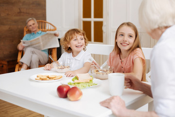Positive sincere cute family gathering for breakfast