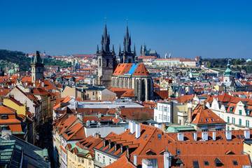 Fototapeta na wymiar Overview of Prague rooftops, Church of our Lady before Tyn and Prague Castle on a sunny day