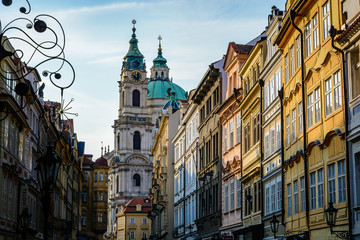 Fototapeta na wymiar View of traditional buildings in Prague with St. Nicholas Church in background