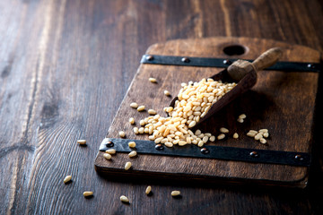 Pine Nut , in Vintage shovel on Wooden Background.Vegetarian.Concept of Healthy Food.Copy space. selective focus.