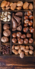Nuts Mixed in a Wooden Vintage Box.Assortment, Walnuts,Pecan,Peanuts,Almonds,Hazelnuts,Macadamia,Cashews,Pistachios.Concept of Healthy Eating.Vegetarian.selective focus.